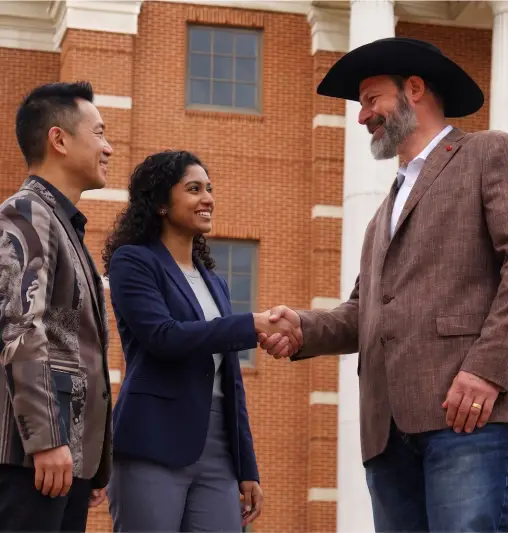 A garnishment defense attorney shaking hands with a client outside the courthouse