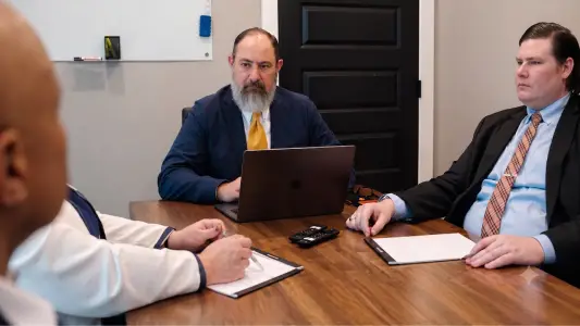 Attorneys reviewing a garnishment case at a conference table